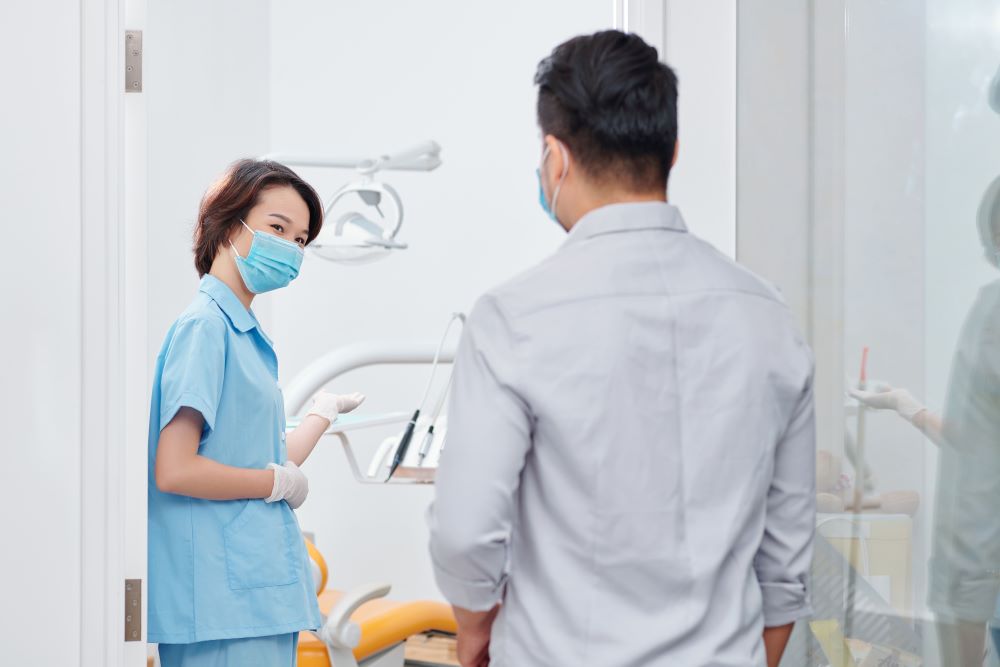 dental nurse inviting patient ESXZZV3