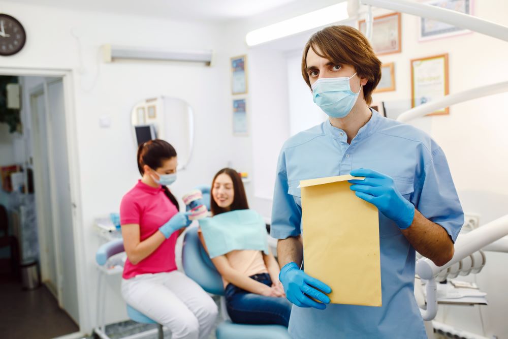 dentist with documents in hands UGE6K5L