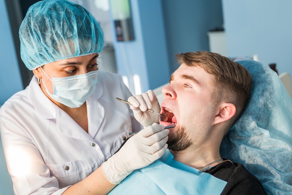 dentist doing a dental treatment on a patient P7H2UAX