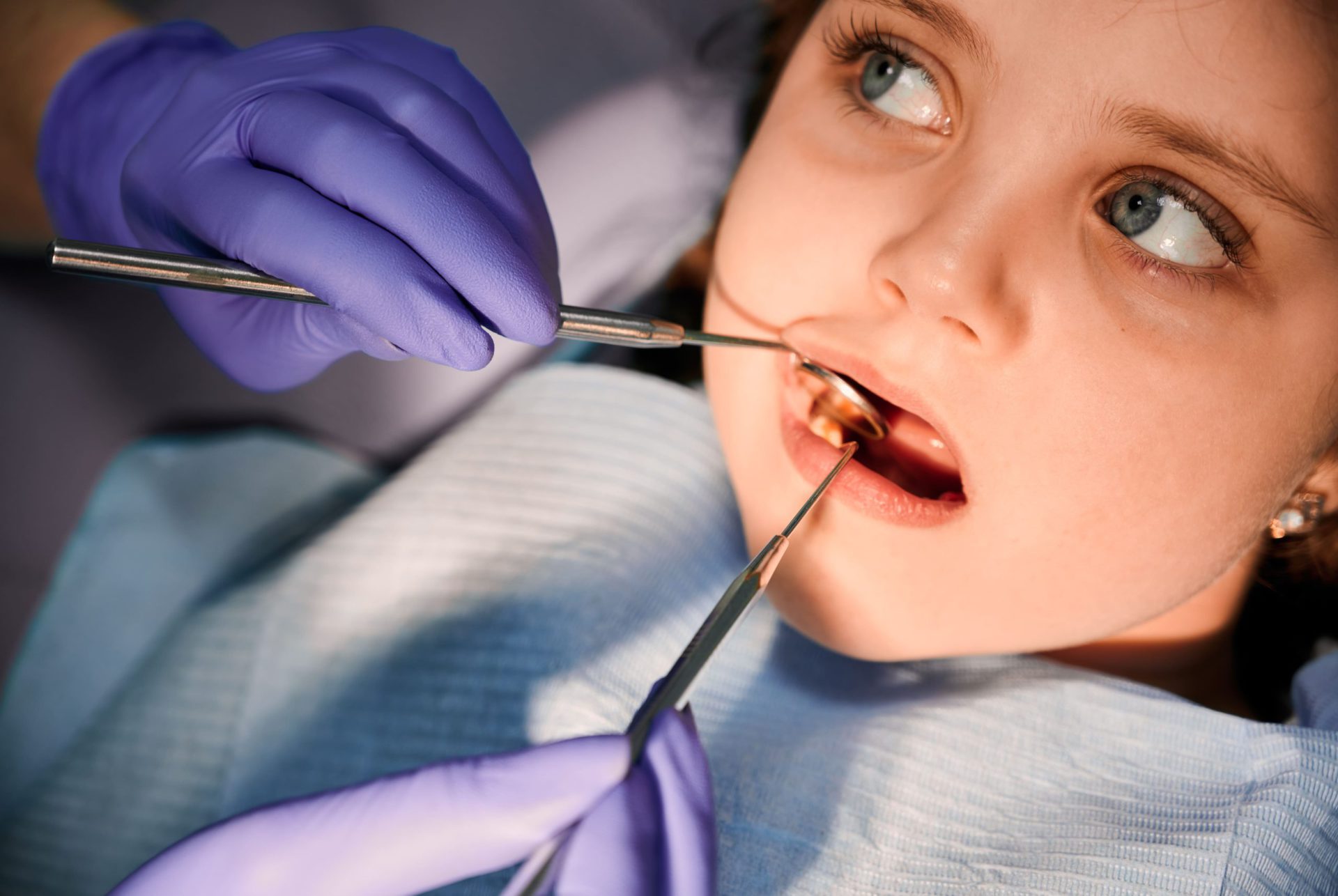 female dentist examining little girl teeth in dent 2022 05 30 22 49 58 utc 1 scaled