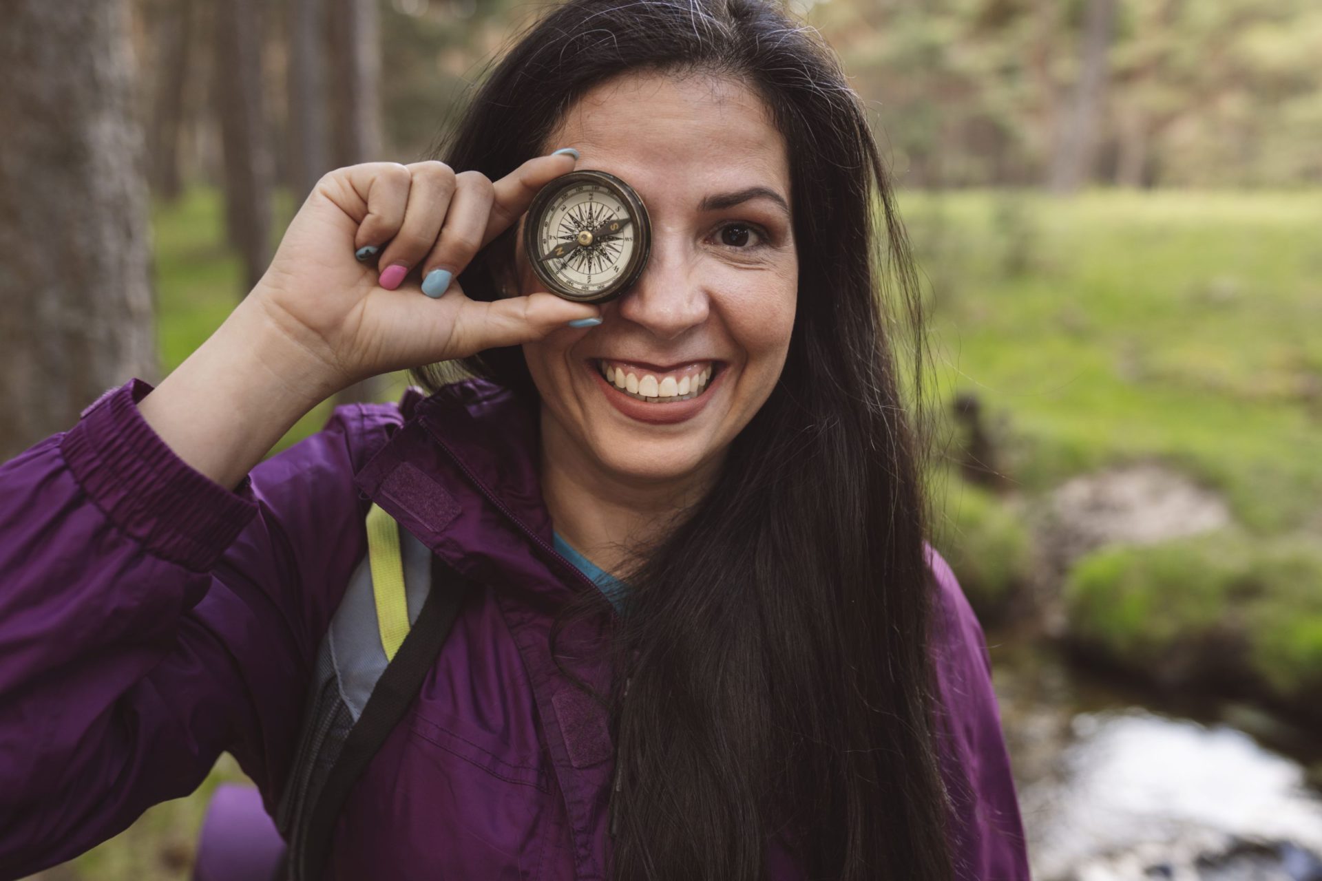 mature woman backpacker with a compass smiling 2022 07 07 23 27 57 utc 1 scaled